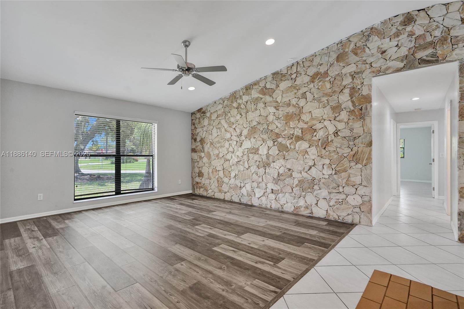14940 Southwest 164th Terrace Miami, FL 33187 - Photo 19 of 73 wooden floor in an empty room with a window