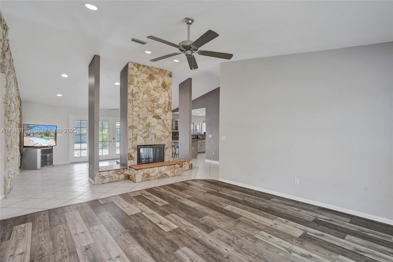 14940 Southwest 164th Terrace Miami, FL 33187 - Photo 22 of 73 a living room with furniture and a fireplace