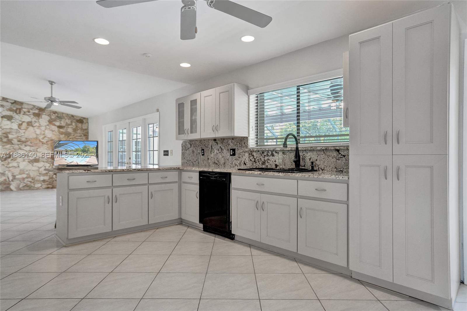 14940 Southwest 164th Terrace Miami, FL 33187 - Photo 29 of 73 a kitchen with white cabinets and sink