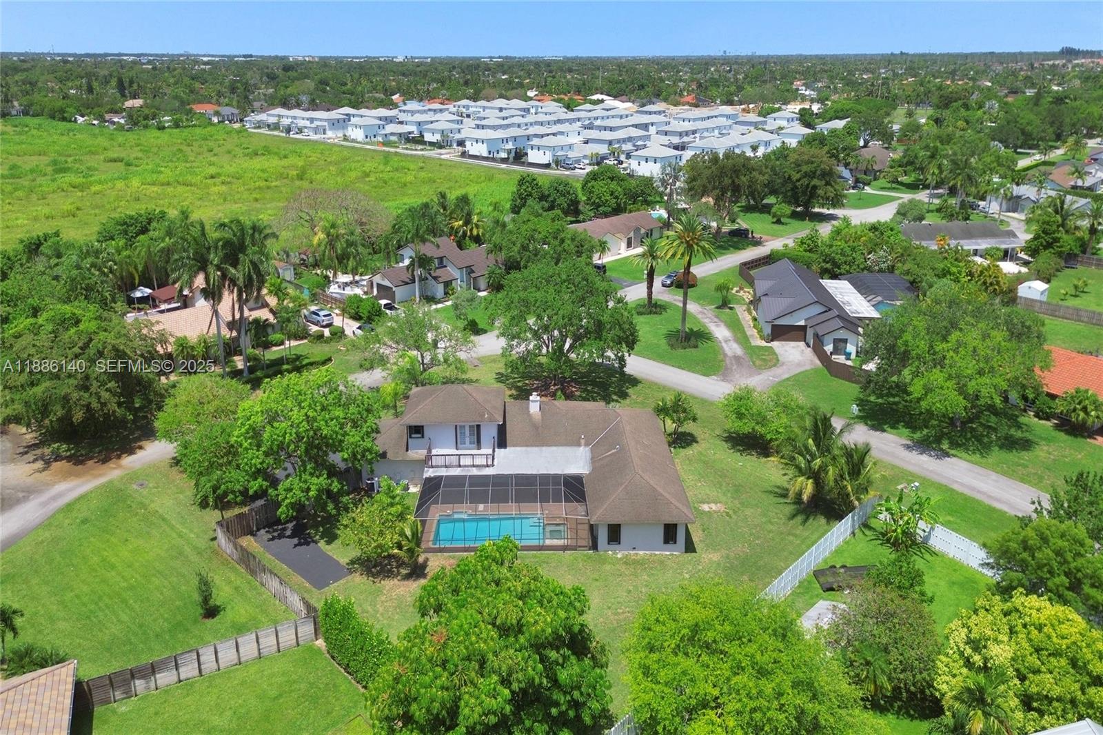 14940 Southwest 164th Terrace Miami, FL 33187 - Photo 3 of 73 an aerial view of residential houses with outdoor space and trees