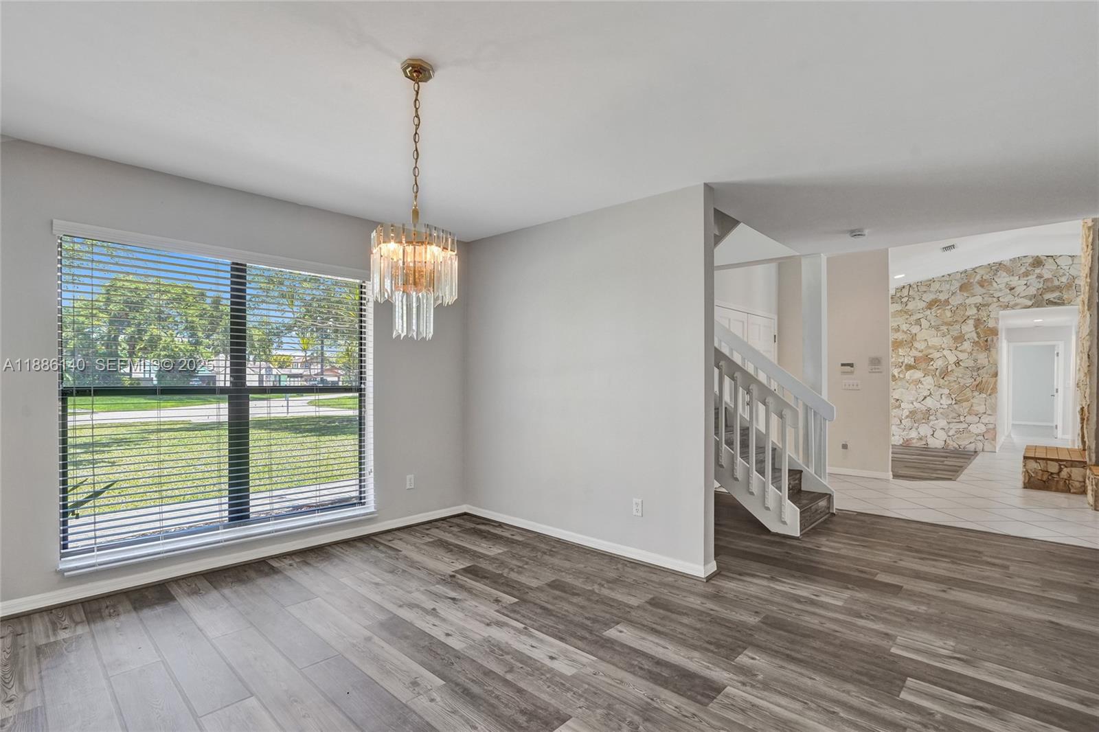 14940 Southwest 164th Terrace Miami, FL 33187 - Photo 33 of 73 a view of empty room with wooden floor and fan