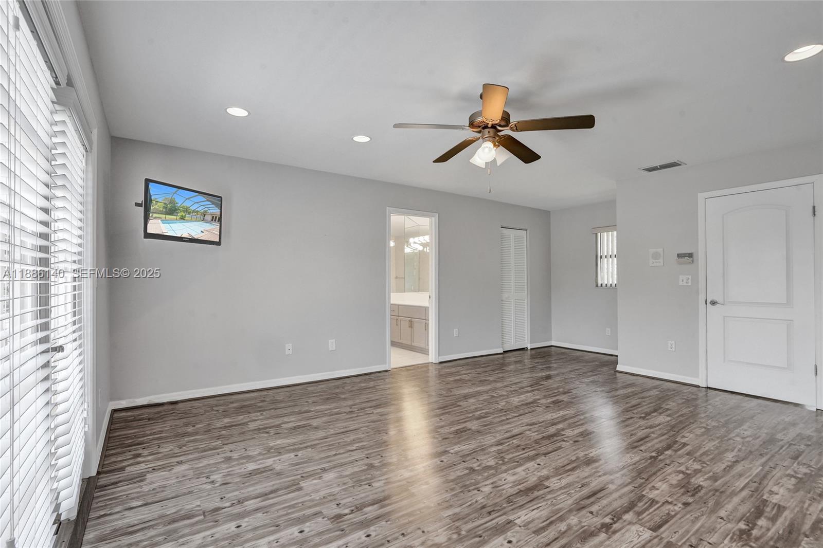 14940 Southwest 164th Terrace Miami, FL 33187 - Photo 36 of 73 wooden floor in an empty room with a window