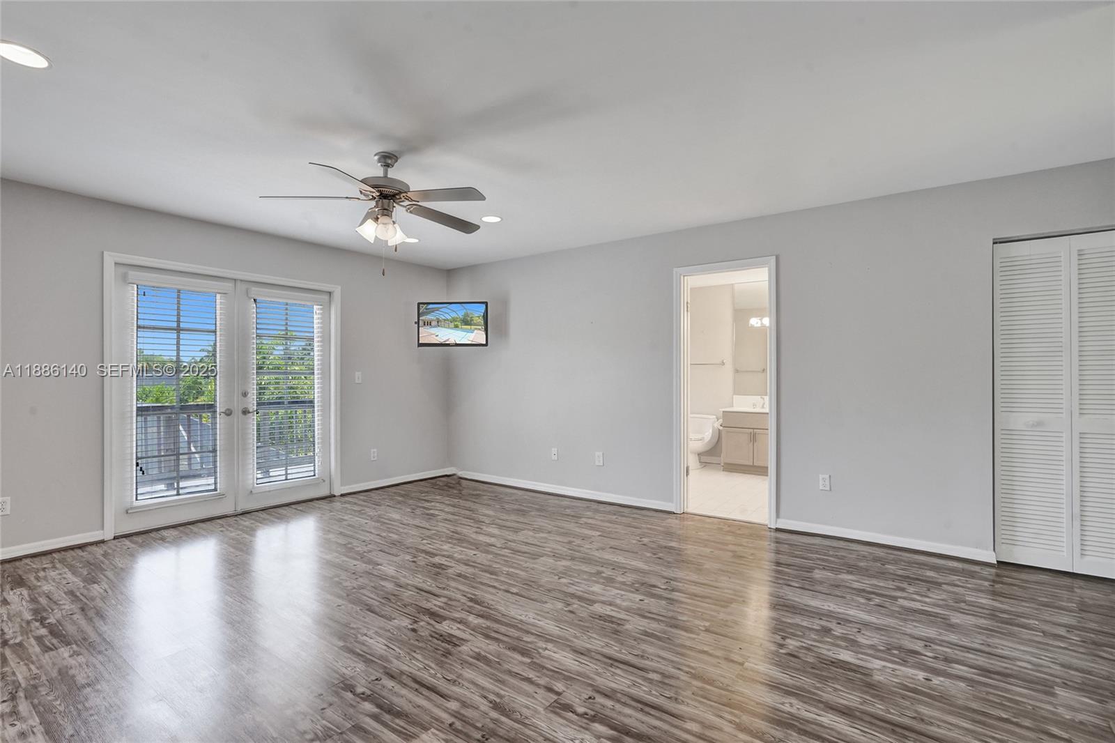 14940 Southwest 164th Terrace Miami, FL 33187 - Photo 37 of 73 a view of an empty room with wooden floor and a window