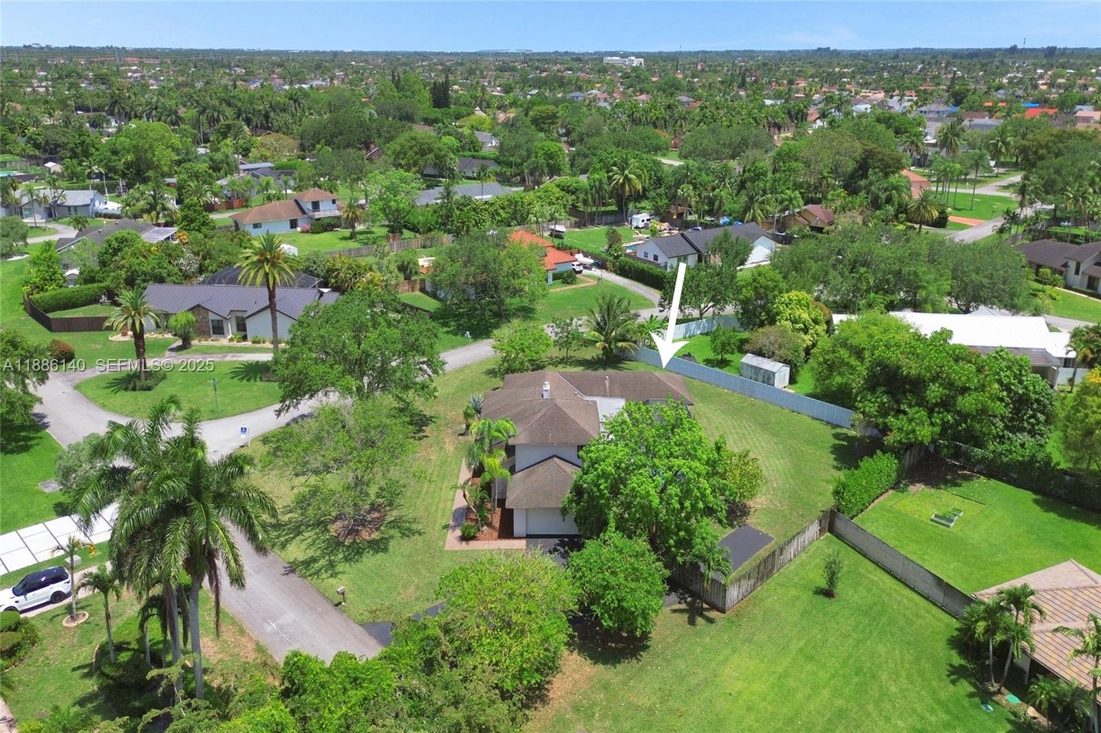 14940 Southwest 164th Terrace Miami, FL 33187 - Photo 4 of 73 an aerial view of green landscape with trees houses and mountain view