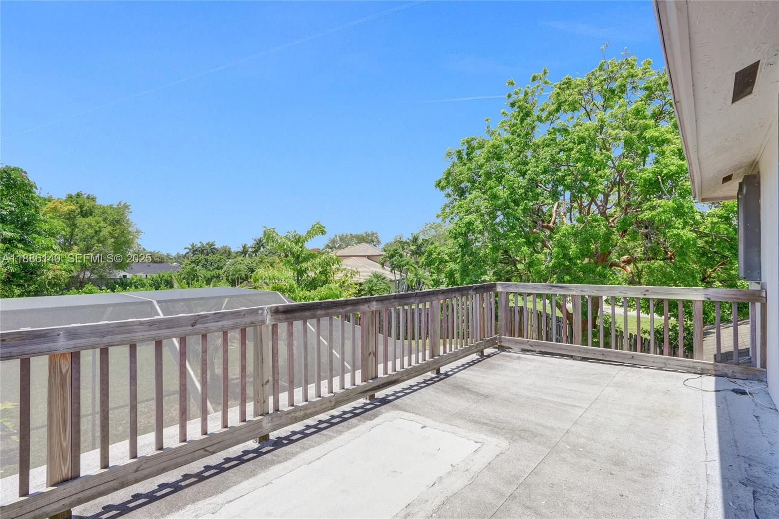 14940 Southwest 164th Terrace Miami, FL 33187 - Photo 41 of 73 a balcony with trees in front of it