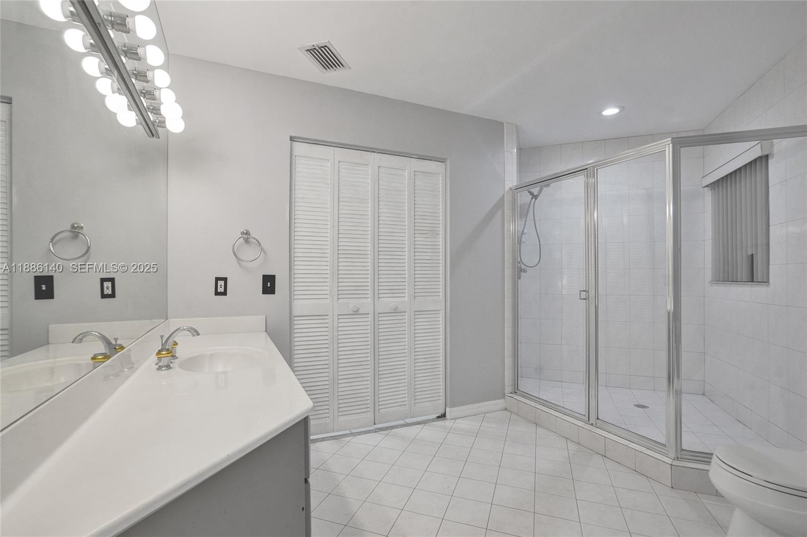 14940 Southwest 164th Terrace Miami, FL 33187 - Photo 45 of 73 a bathroom with a sink a mirror and shower