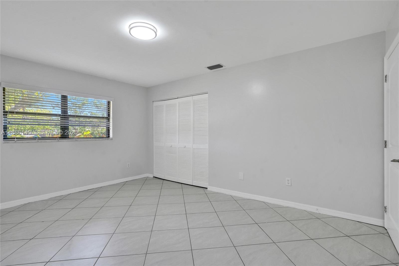 14940 Southwest 164th Terrace Miami, FL 33187 - Photo 49 of 73 a view of an empty room with a window