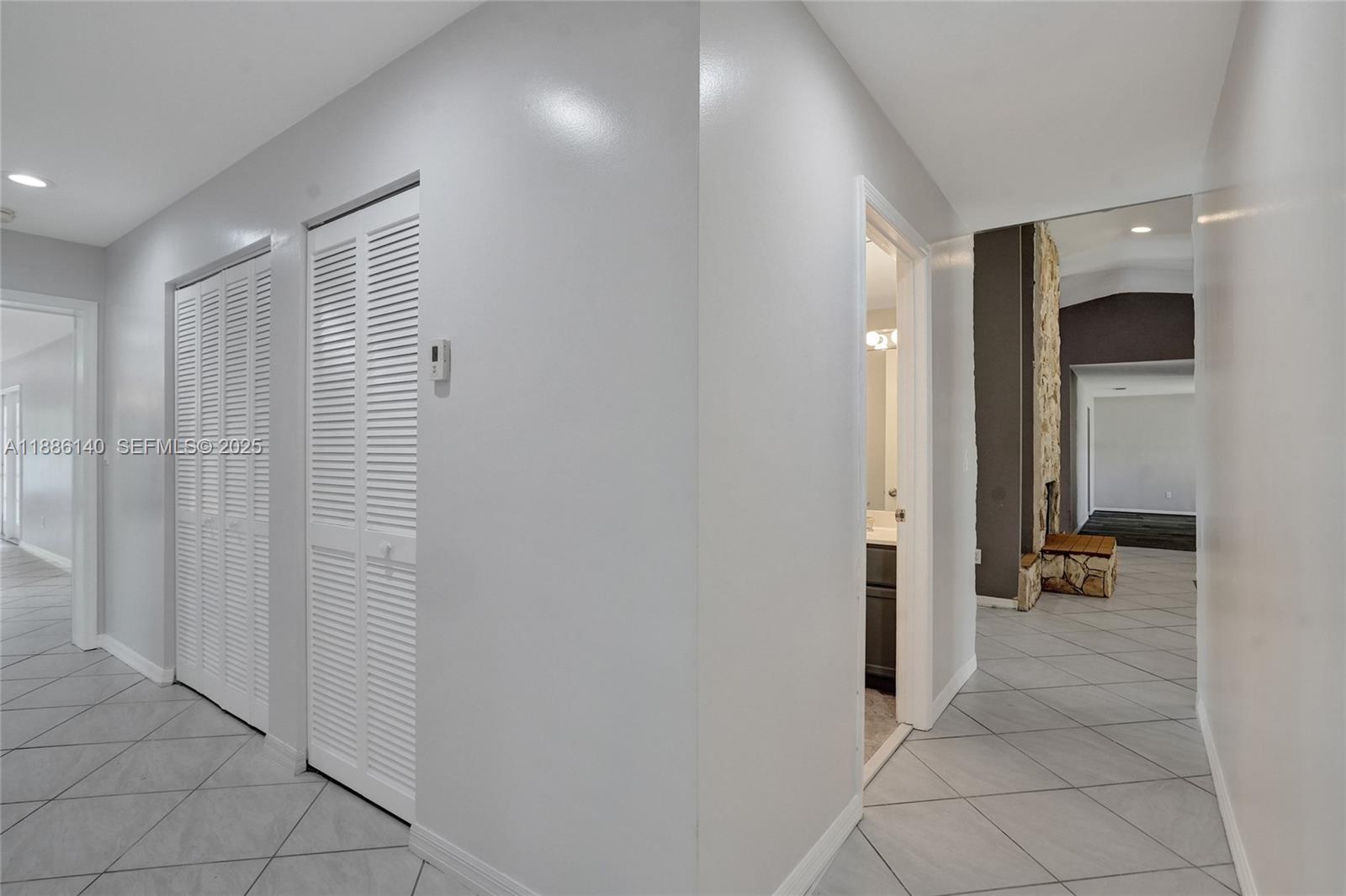 14940 Southwest 164th Terrace Miami, FL 33187 - Photo 55 of 73 a view of a hallway with closet and a bathroom