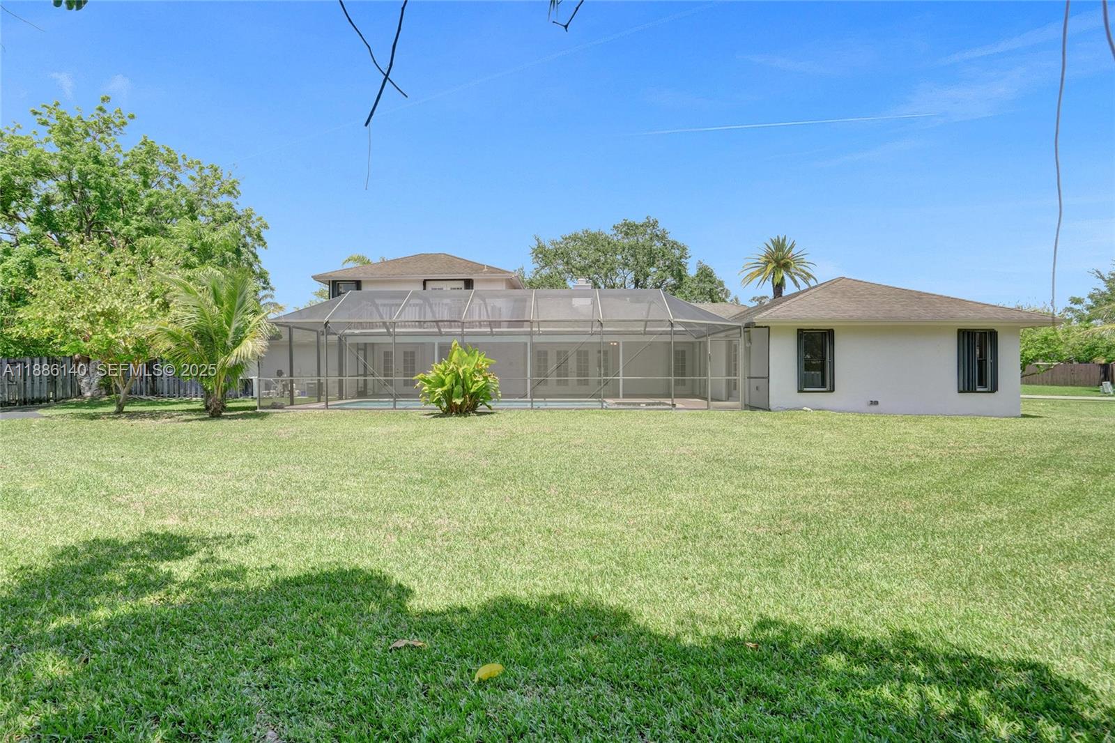 14940 Southwest 164th Terrace Miami, FL 33187 - Photo 59 of 73 a front view of a house with a garden