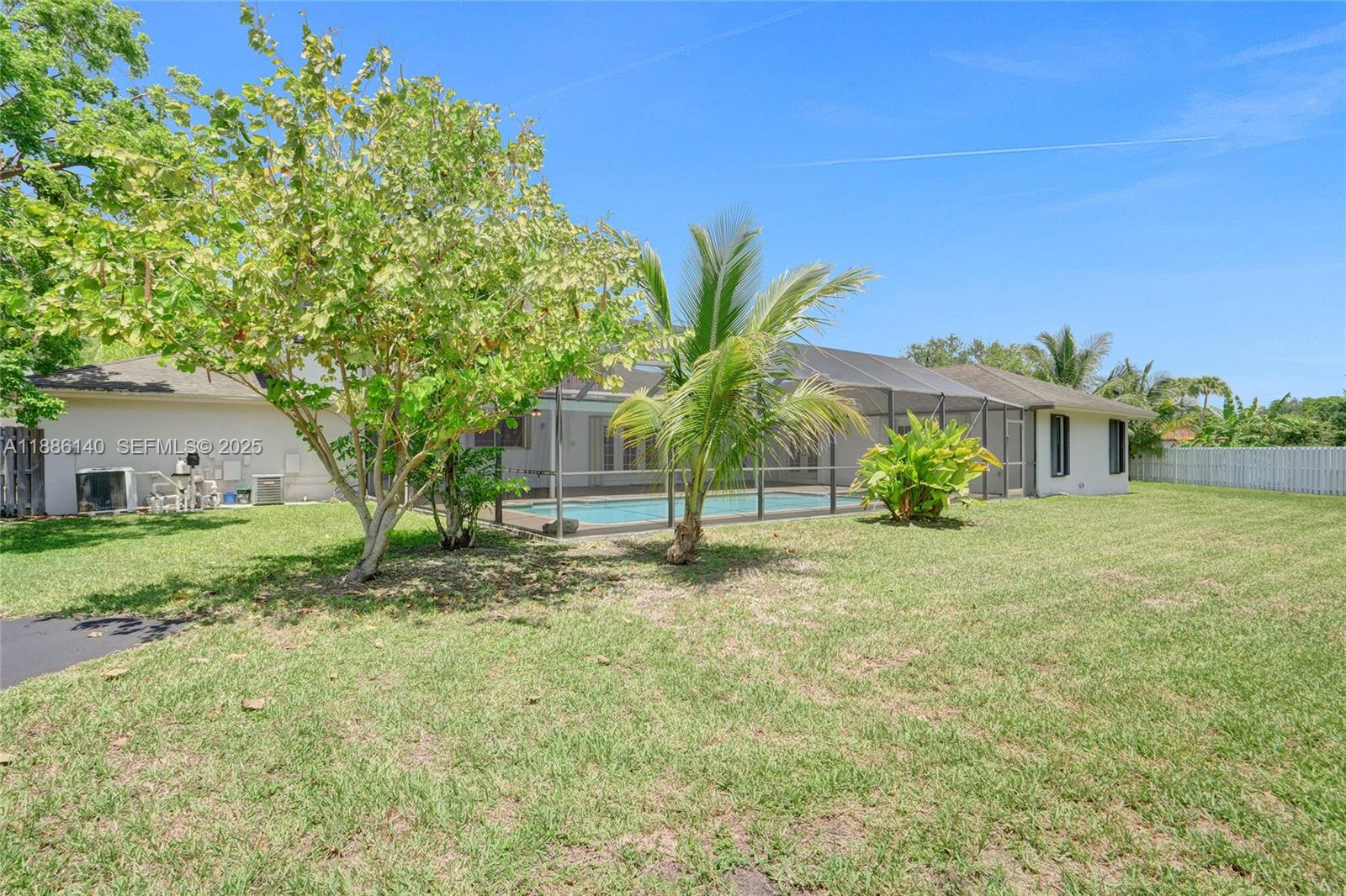 14940 Southwest 164th Terrace Miami, FL 33187 - Photo 60 of 73 a house with a tree in front of it