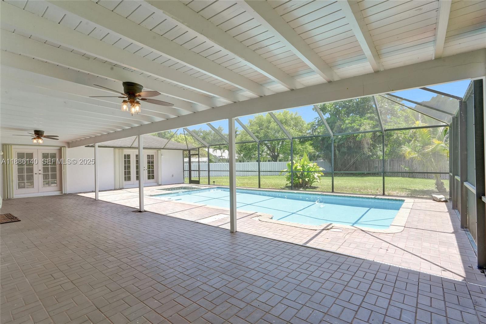 14940 Southwest 164th Terrace Miami, FL 33187 - Photo 63 of 73 a view of empty room with wooden floor and fan