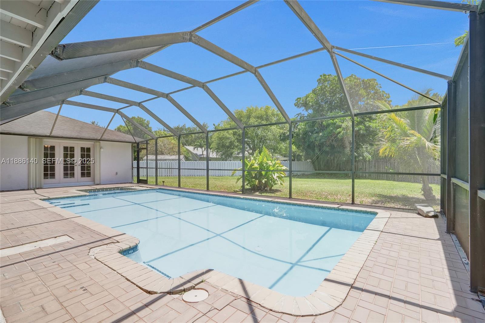 14940 Southwest 164th Terrace Miami, FL 33187 - Photo 65 of 73 a view of an empty room with a floor to ceiling window
