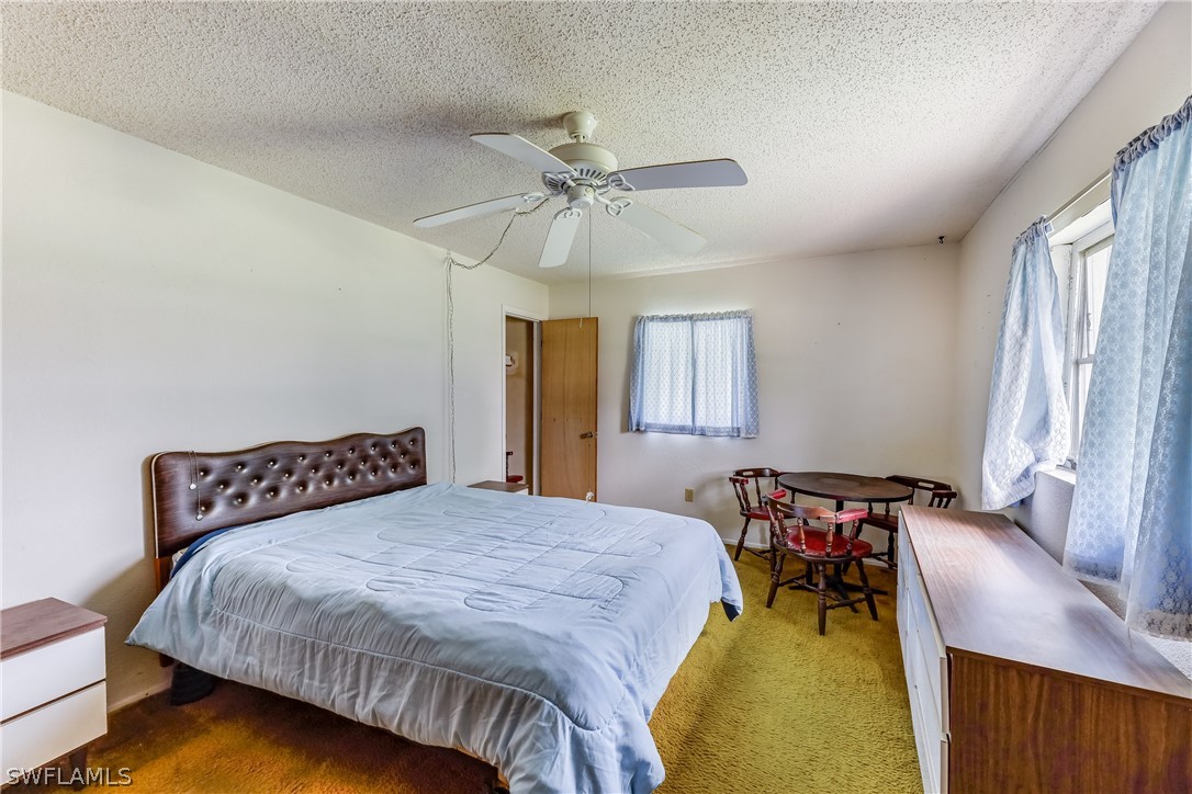 2807 W Road Fort Myers, FL 33905 - Photo 20 of 27 a bedroom with a bed and a chair