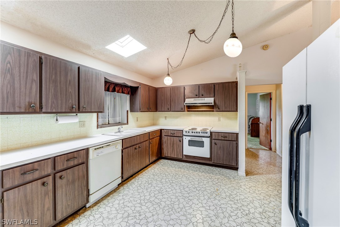 2807 W Road Fort Myers, FL 33905 - Photo 8 of 27 a kitchen with stainless steel appliances granite countertop a refrigerator a stove top oven a sink and dishwasher