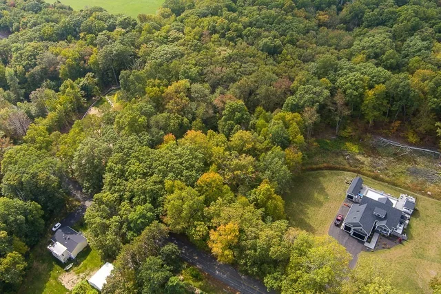 an aerial view of a house with a lake view