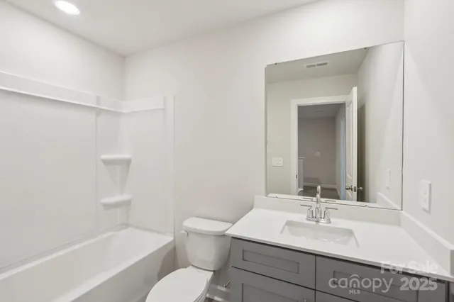 a bathroom with a sink toilet a bathtub and vanity