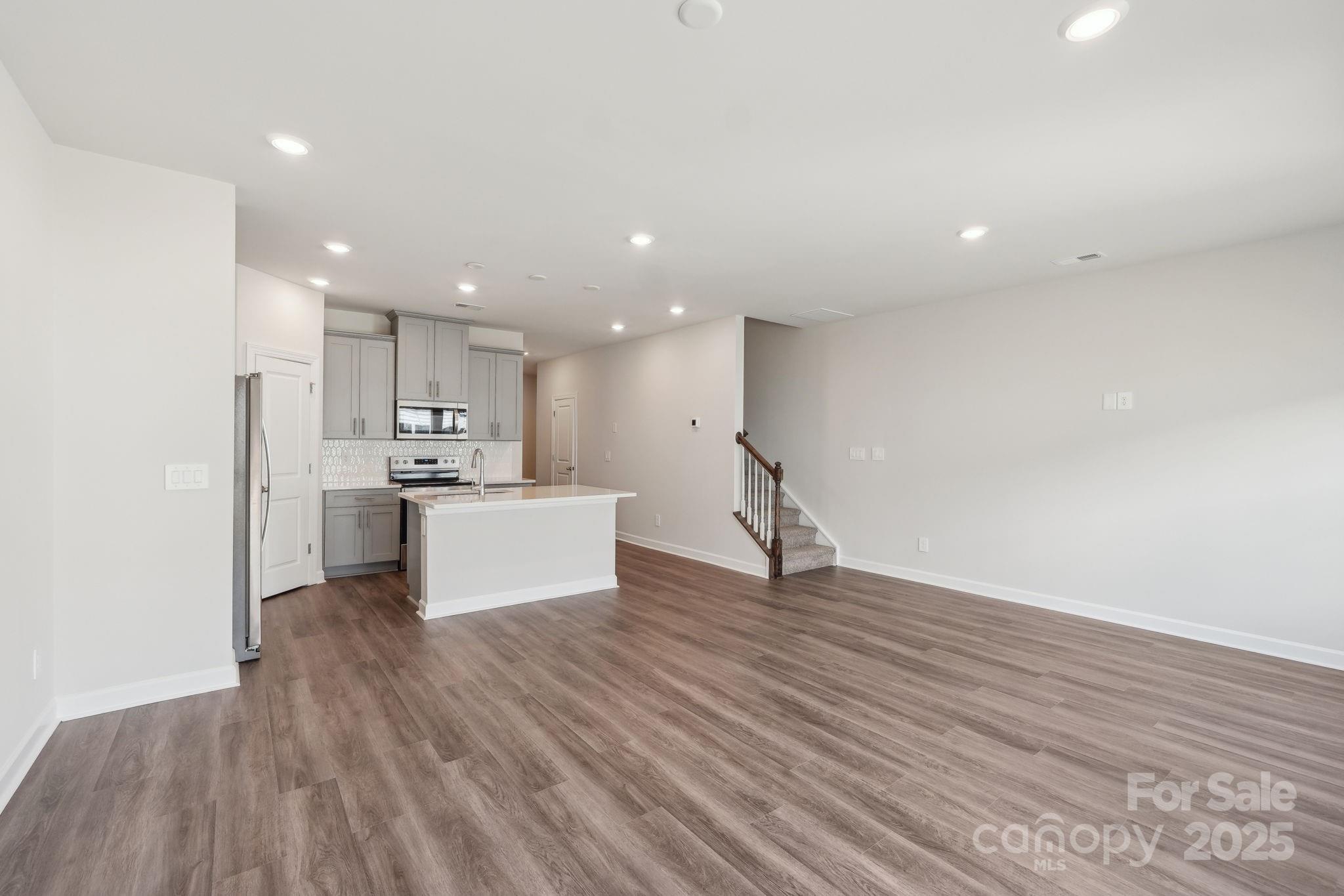254 Tiger Lily Drive Fort Mill, SC 29708 - Photo 3 of 18 a view of kitchen view wooden floors appliances and cabinets