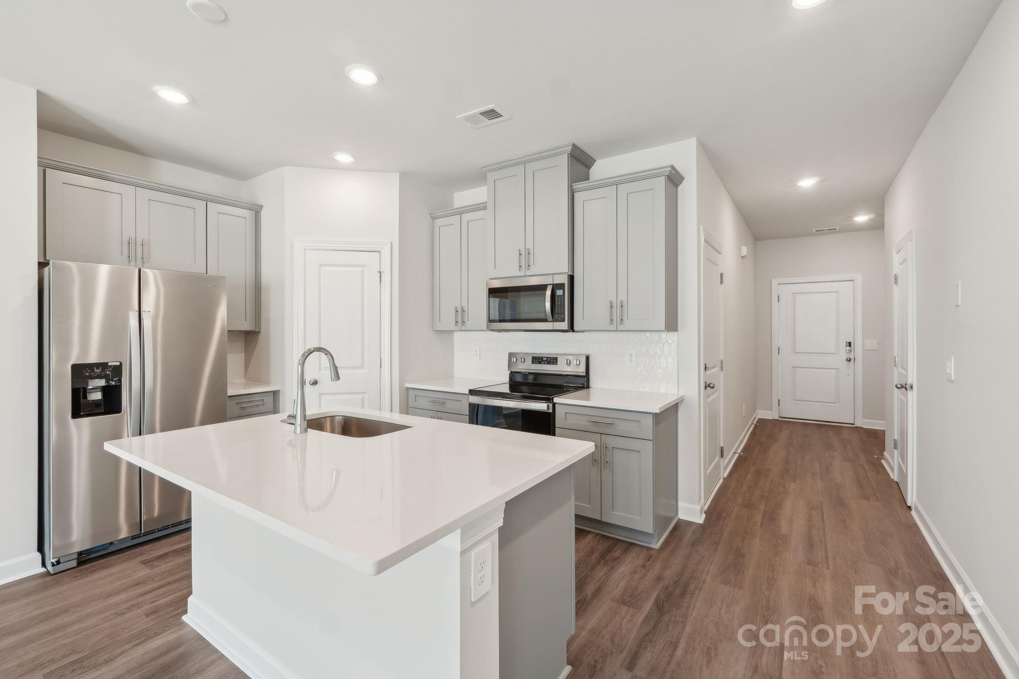254 Tiger Lily Drive Fort Mill, SC 29708 - Photo 6 of 18 a kitchen with stainless steel appliances a refrigerator sink and microwave