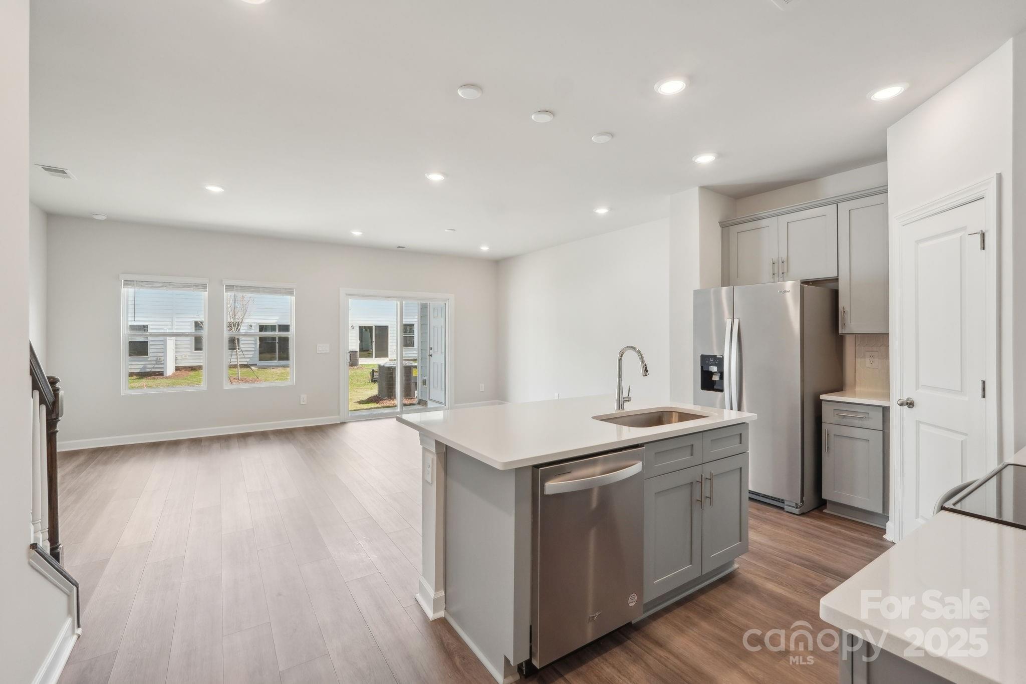 254 Tiger Lily Drive Fort Mill, SC 29708 - Photo 9 of 18 a kitchen with stainless steel appliances granite countertop a sink stove and refrigerator