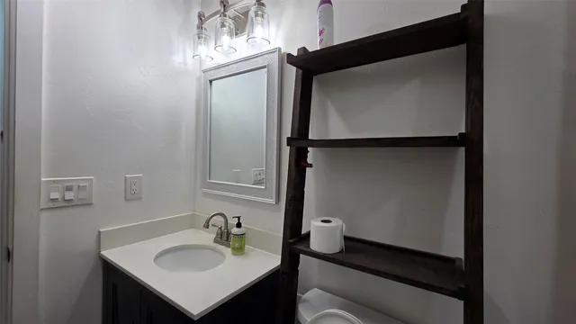 a bathroom with a sink and mirror