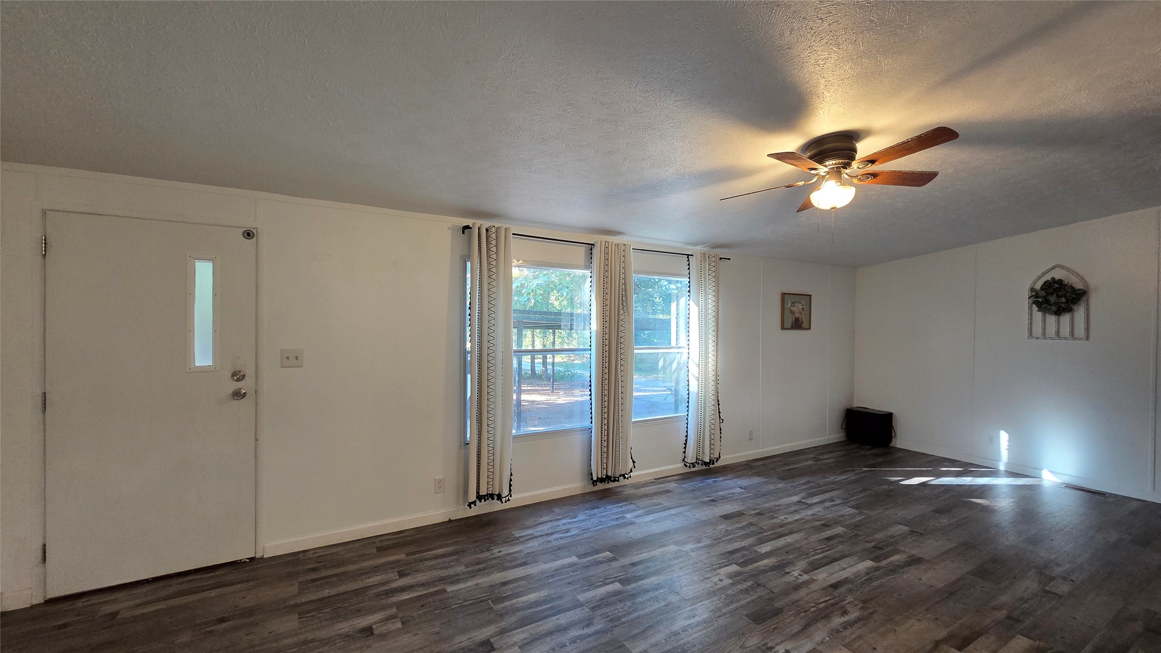 21150 Arnsworth Road Montgomery, TX 77356 - Photo 7 of 16 a view of an empty room with a window and wooden floor