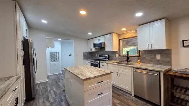 a kitchen with a sink stove and refrigerator