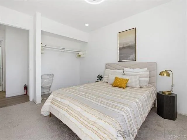 9462 Doheny Road Santee, CA 92071 - Photo 31 of 33 a bedroom with a bed and a mirror