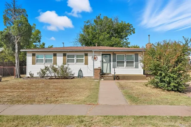 a front view of a house with yard patio and outdoor seating