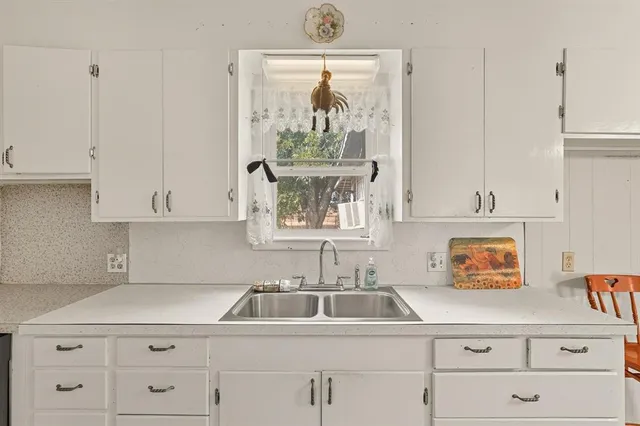 a kitchen with cabinets and a window
