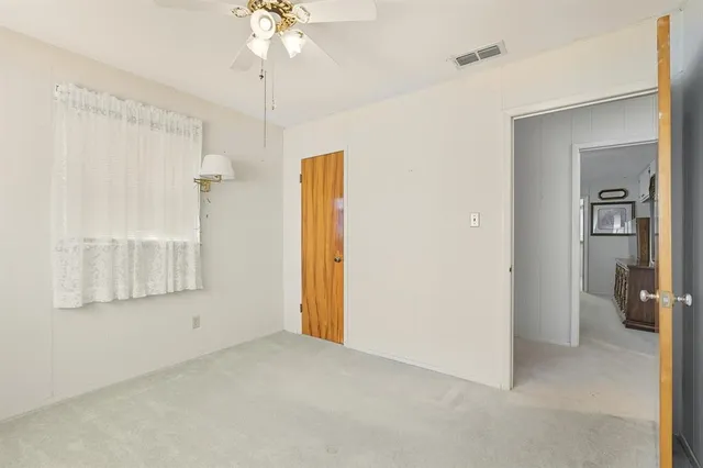 an empty room with a empty space and a ceiling fan