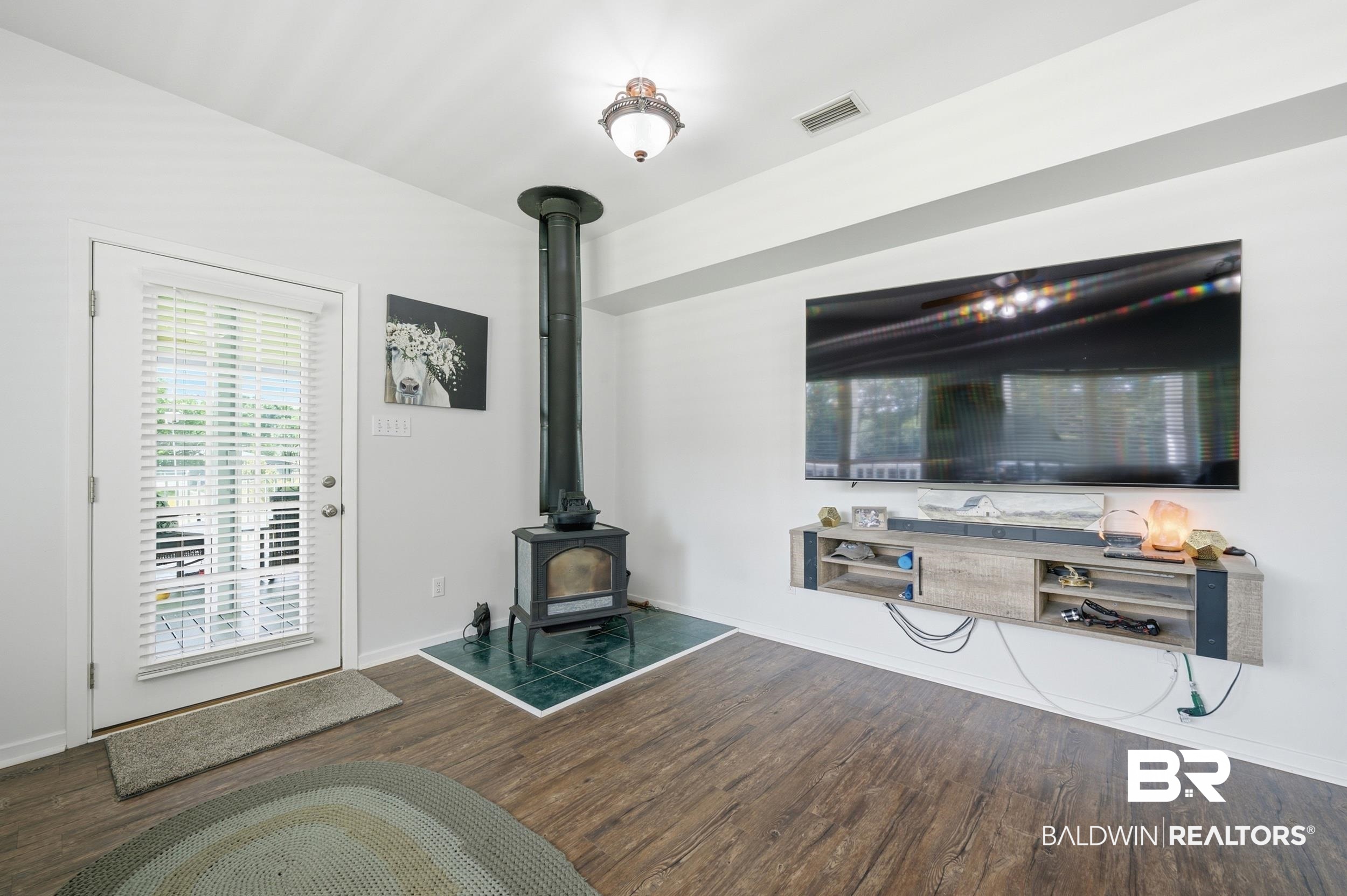 15855 Calvin Richerson Road Bay Minette, AL 36507 - Photo 36 of 83 Living area featuring wood-finish flooring and a white ceiling