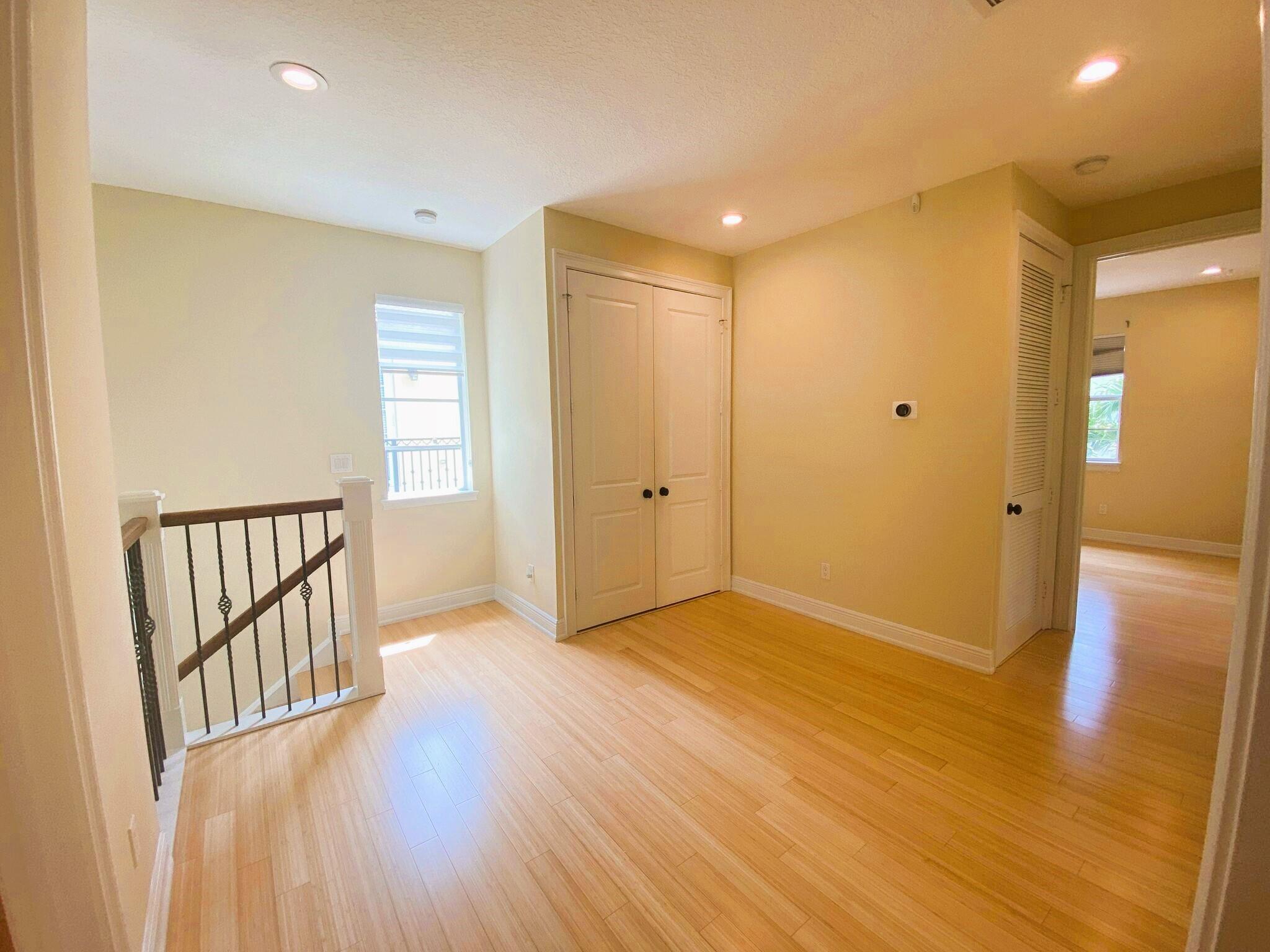 50 Via Poinciana Lane Boca Raton, FL 33487 - Photo 23 of 51 an empty room with wooden floor and windows