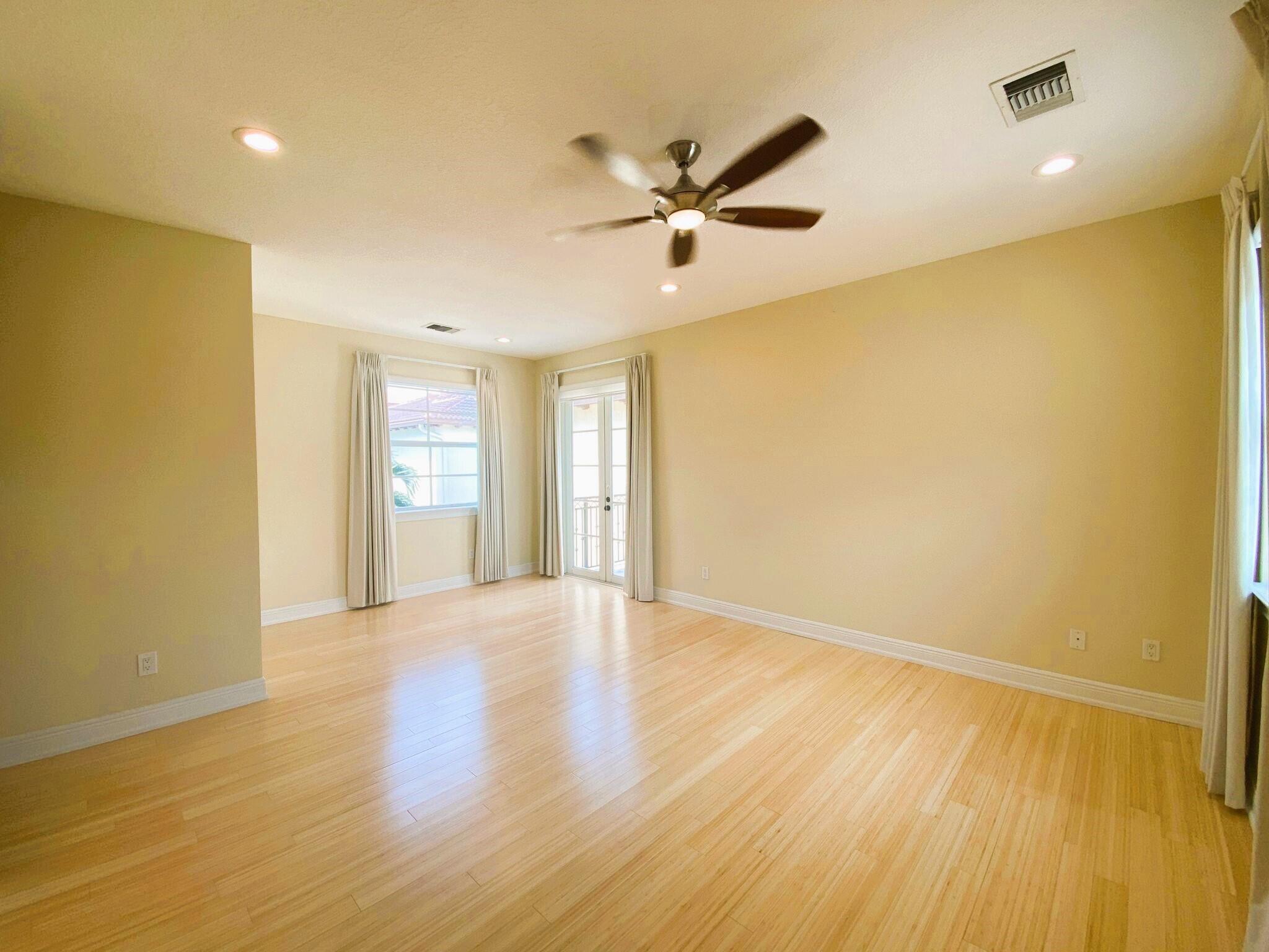 50 Via Poinciana Lane Boca Raton, FL 33487 - Photo 28 of 51 a view of an empty room with wooden floor and a window