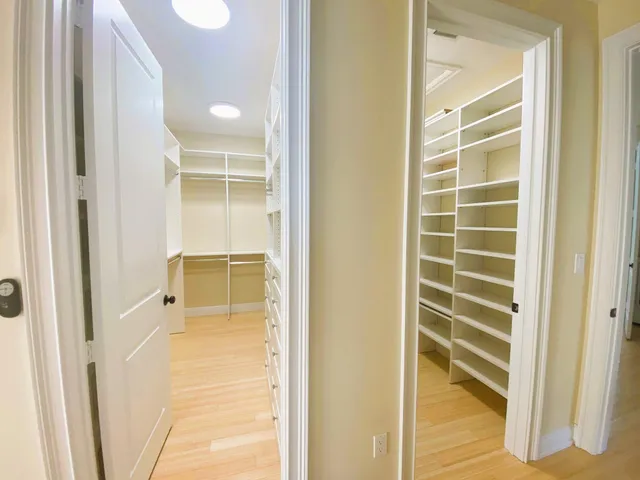 a view of walk in closet with empty room