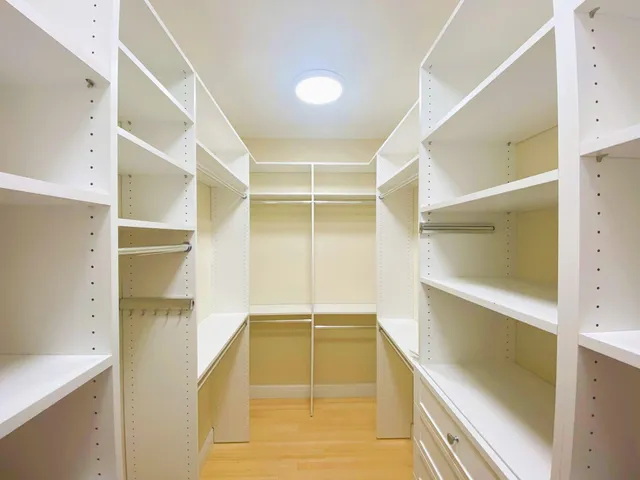 a view of walk in closet with empty racks