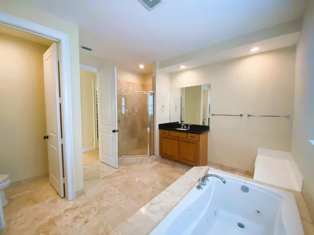 a bathroom with a tub sink and a mirror