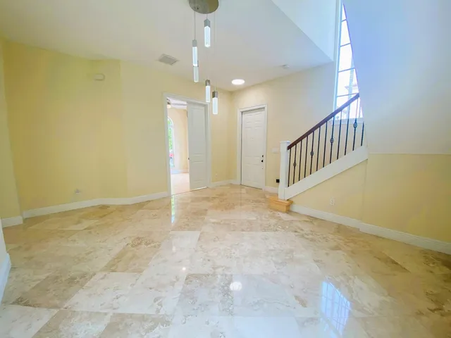 a view of an empty room with stairs