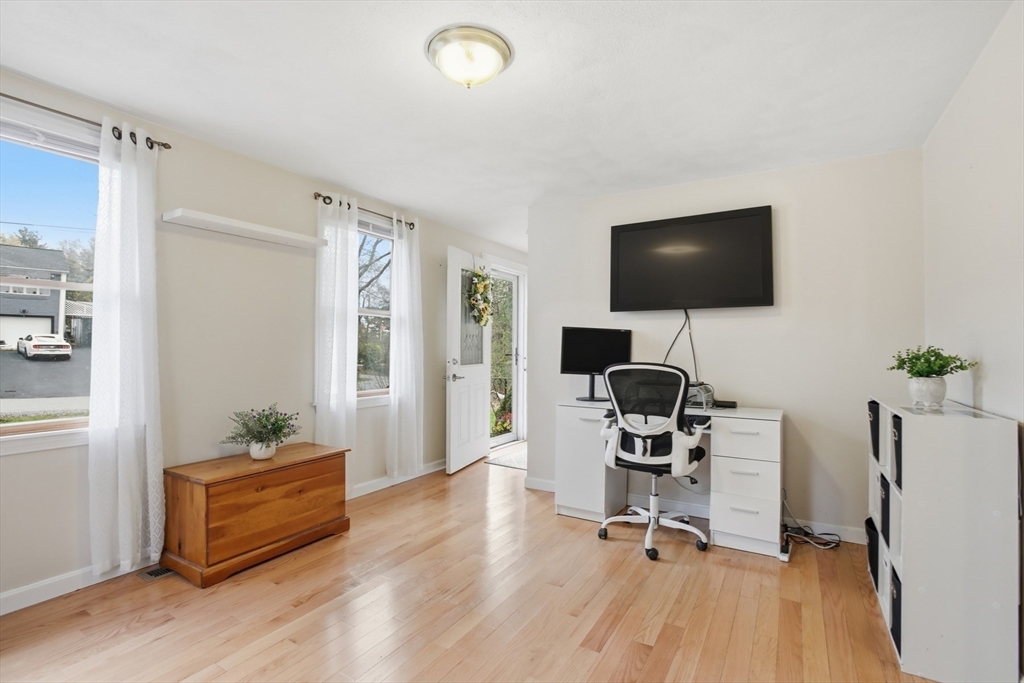 18 Trifiro Road Billerica, MA 01821 - Photo 12 of 42 a view of a livingroom with workspace and a flat screen tv