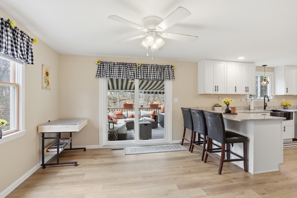 18 Trifiro Road Billerica, MA 01821 - Photo 18 of 42 a kitchen with a dining table chairs and a refrigerator
