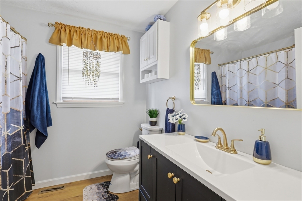 18 Trifiro Road Billerica, MA 01821 - Photo 28 of 42 a bathroom with a sink a toilet and a mirror