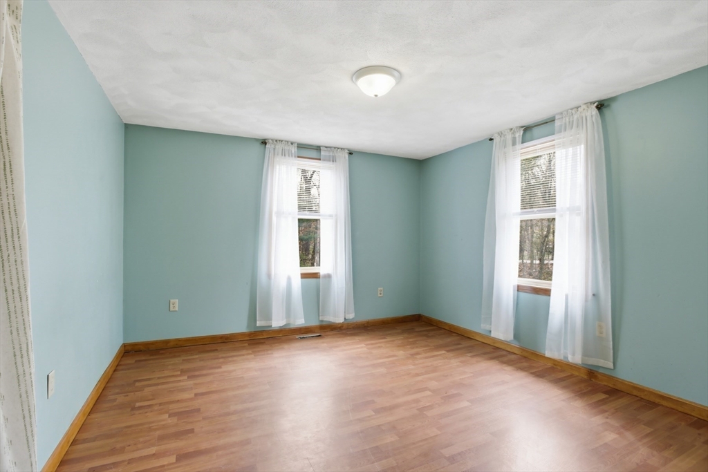 18 Trifiro Road Billerica, MA 01821 - Photo 29 of 42 an empty room with wooden floor and windows