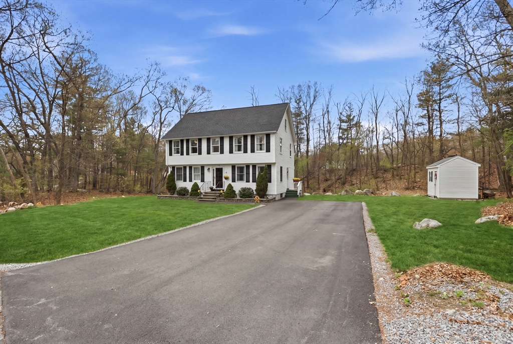 18 Trifiro Road Billerica, MA 01821 - Photo 3 of 42 a view of a white house with a big yard plants and large trees