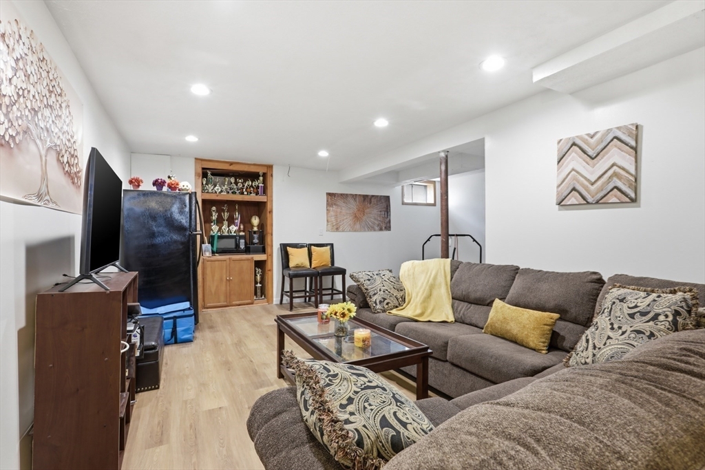 18 Trifiro Road Billerica, MA 01821 - Photo 31 of 42 a living room with furniture and a flat screen tv