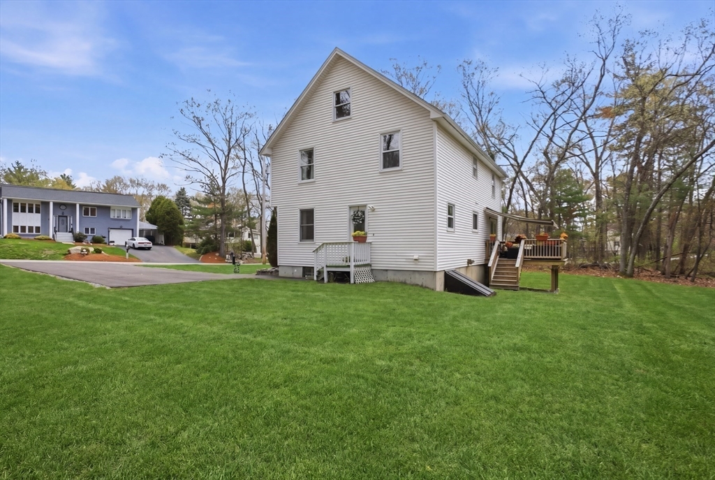 18 Trifiro Road Billerica, MA 01821 - Photo 39 of 42 a view of a white house with a big yard and large trees
