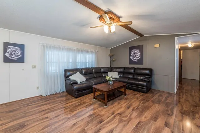 a living room with furniture and a wooden floor