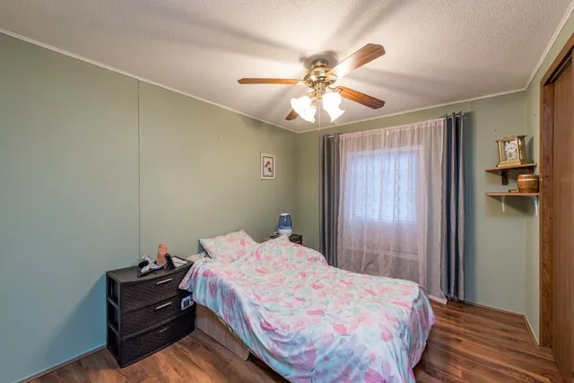 a bedroom with a bed and a chandelier