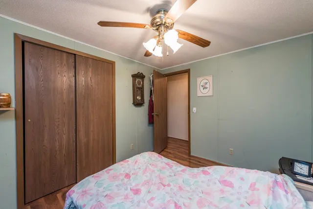 a bedroom with a bed and a chandelier