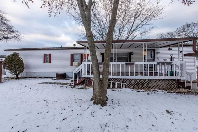 a backyard of a house with barbeque oven fire pit table and chairs