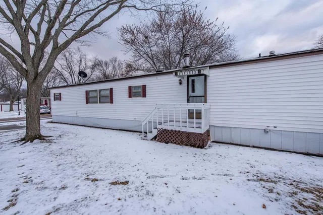 a view of a house with a yard covered in snow