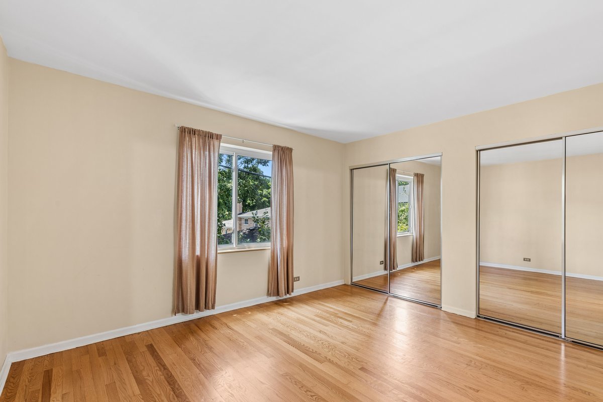 140 Green Bay Road, Unit 2 Glencoe, IL 60022 - Photo 18 of 28 wooden floor in an empty room with a window